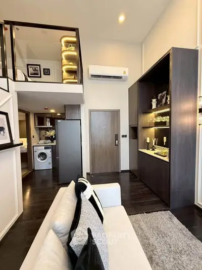 Modern living room with loft design, featuring sleek furniture and built-in storage, perfect for urban living.