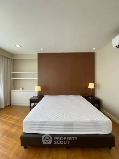 Spacious bedroom with modern design and wooden flooring