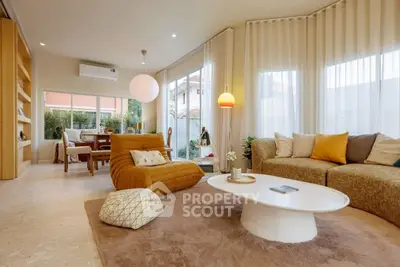 Spacious modern living room with stylish furniture and large windows offering natural light.