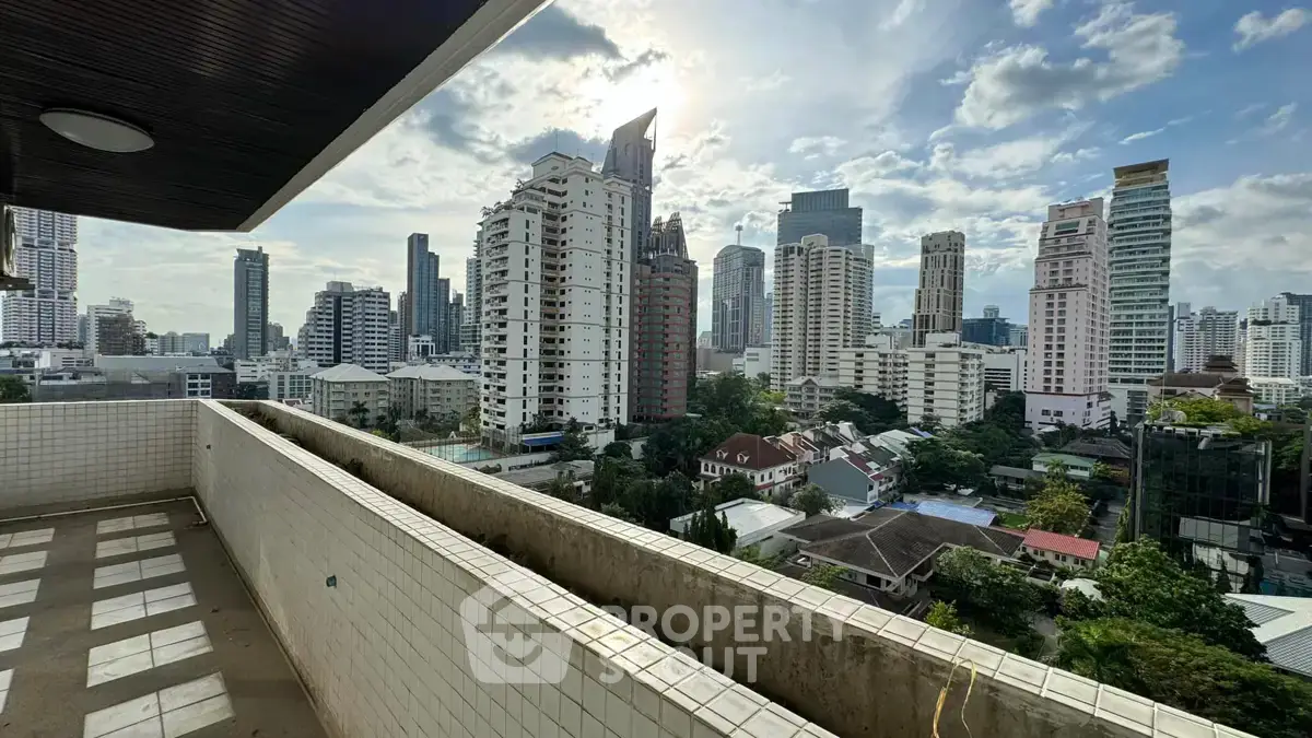 Stunning cityscape view from a spacious balcony in a high-rise building.