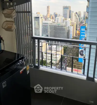 High-rise balcony with stunning cityscape view and modern appliances.