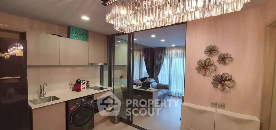 Modern open-layout kitchen with stylish living room view and elegant lighting