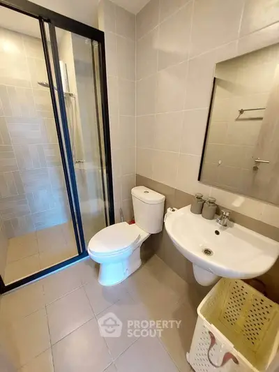 Modern bathroom with sleek design featuring glass shower and contemporary fixtures.