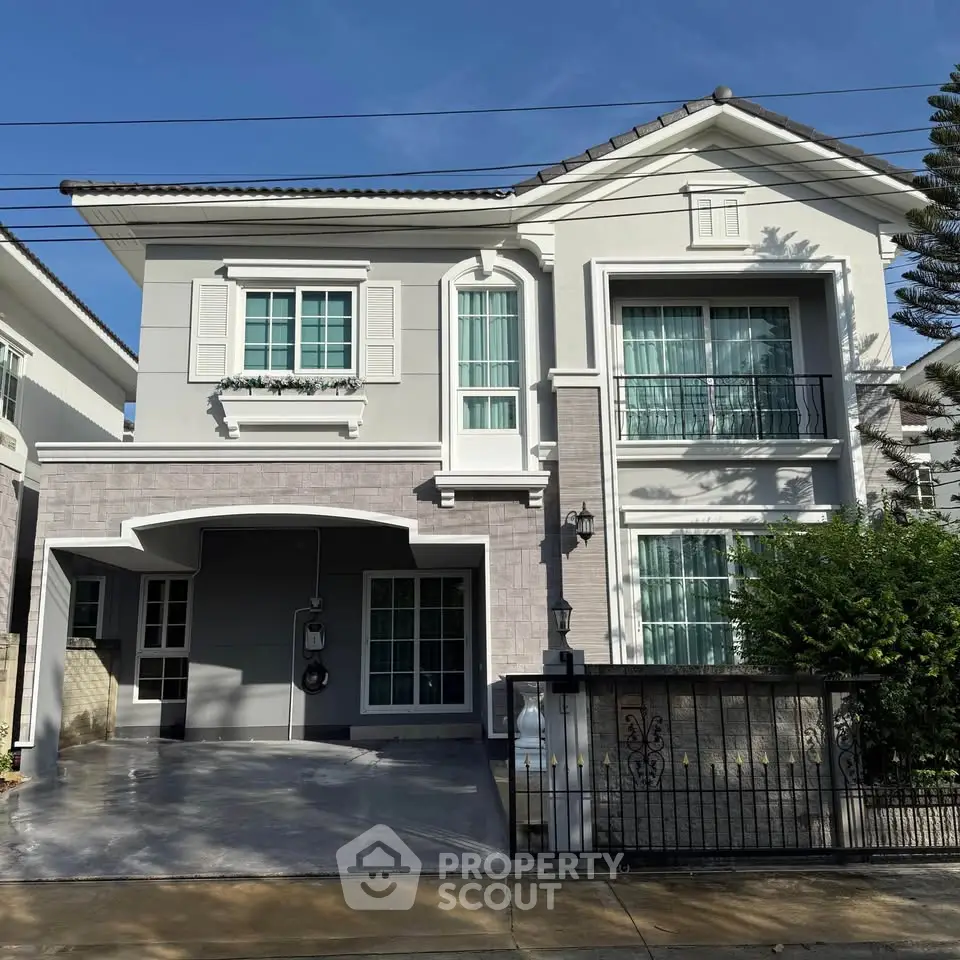 Elegant two-story house with modern facade and spacious driveway in a serene neighborhood.