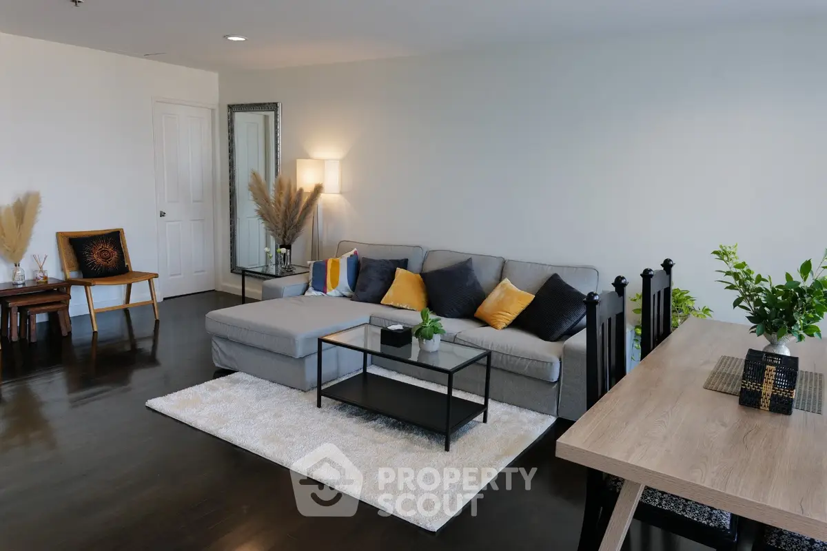 Spacious modern living room with stylish decor and cozy seating area.