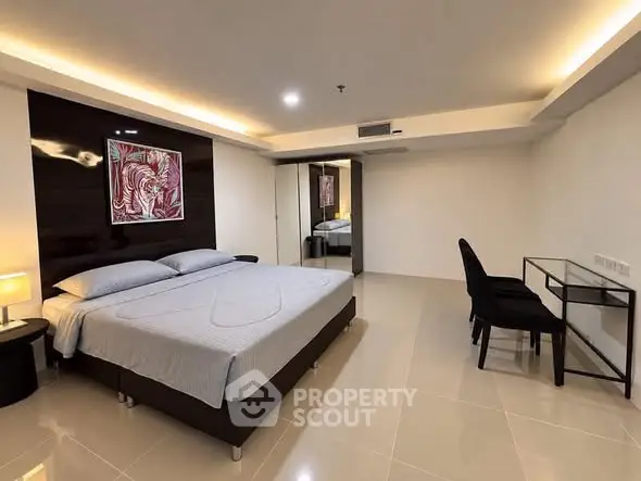 Spacious modern bedroom with elegant decor and sleek furniture