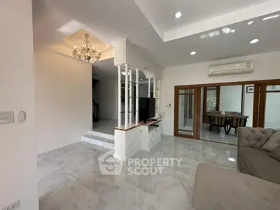 Spacious living room with elegant chandelier and modern design