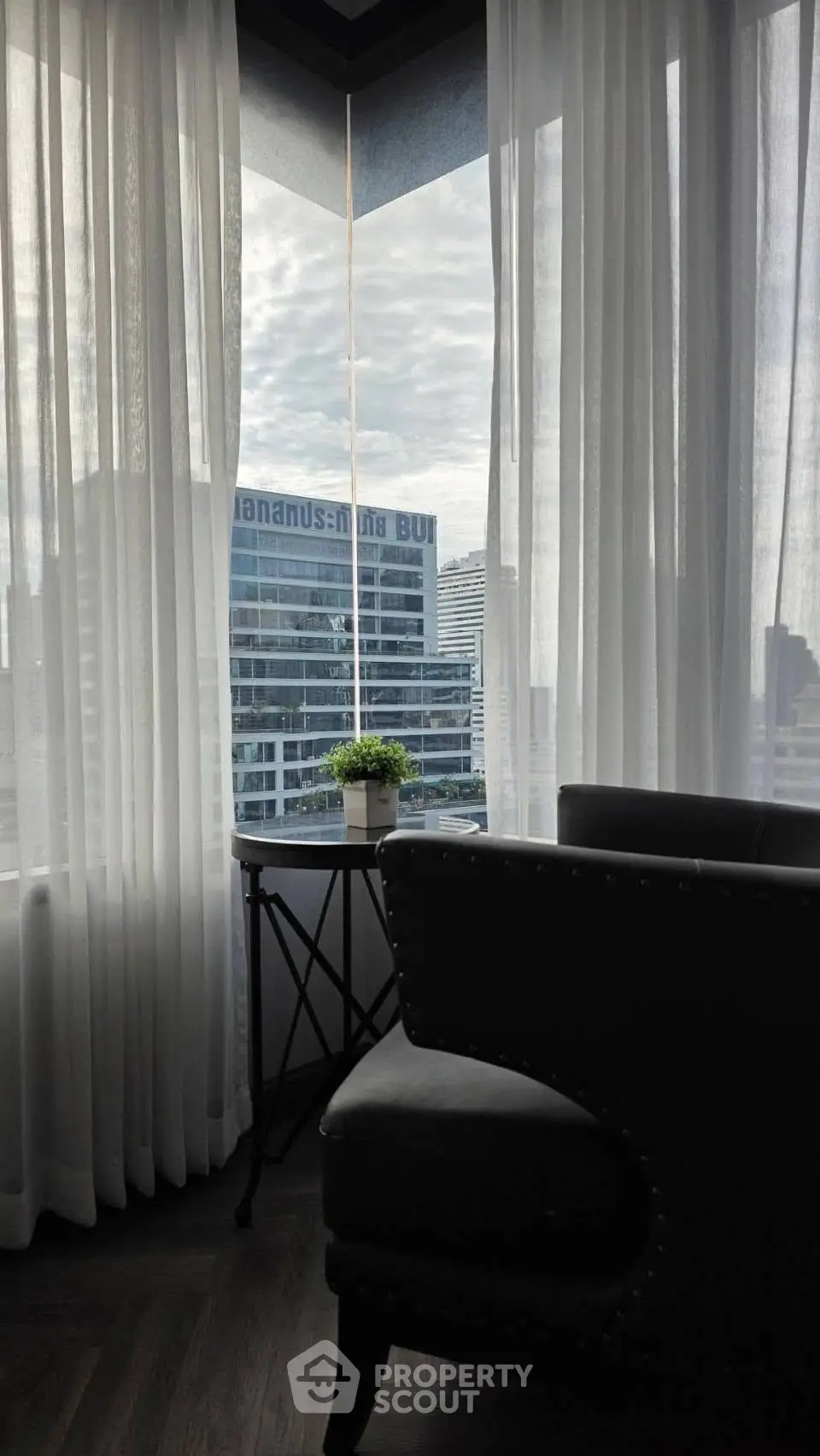 Stylish corner unit with panoramic city view and elegant interior design.