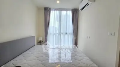 Modern bedroom with large window and air conditioning unit