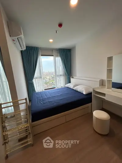 Modern bedroom with city view, featuring a cozy bed, stylish curtains, and a sleek vanity desk.