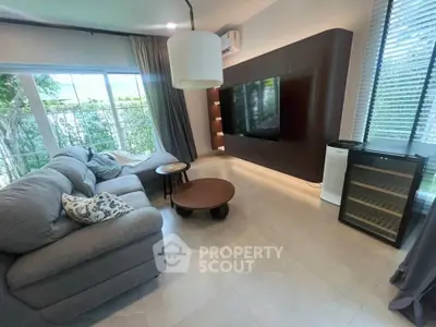Spacious living room with modern decor and large window view
