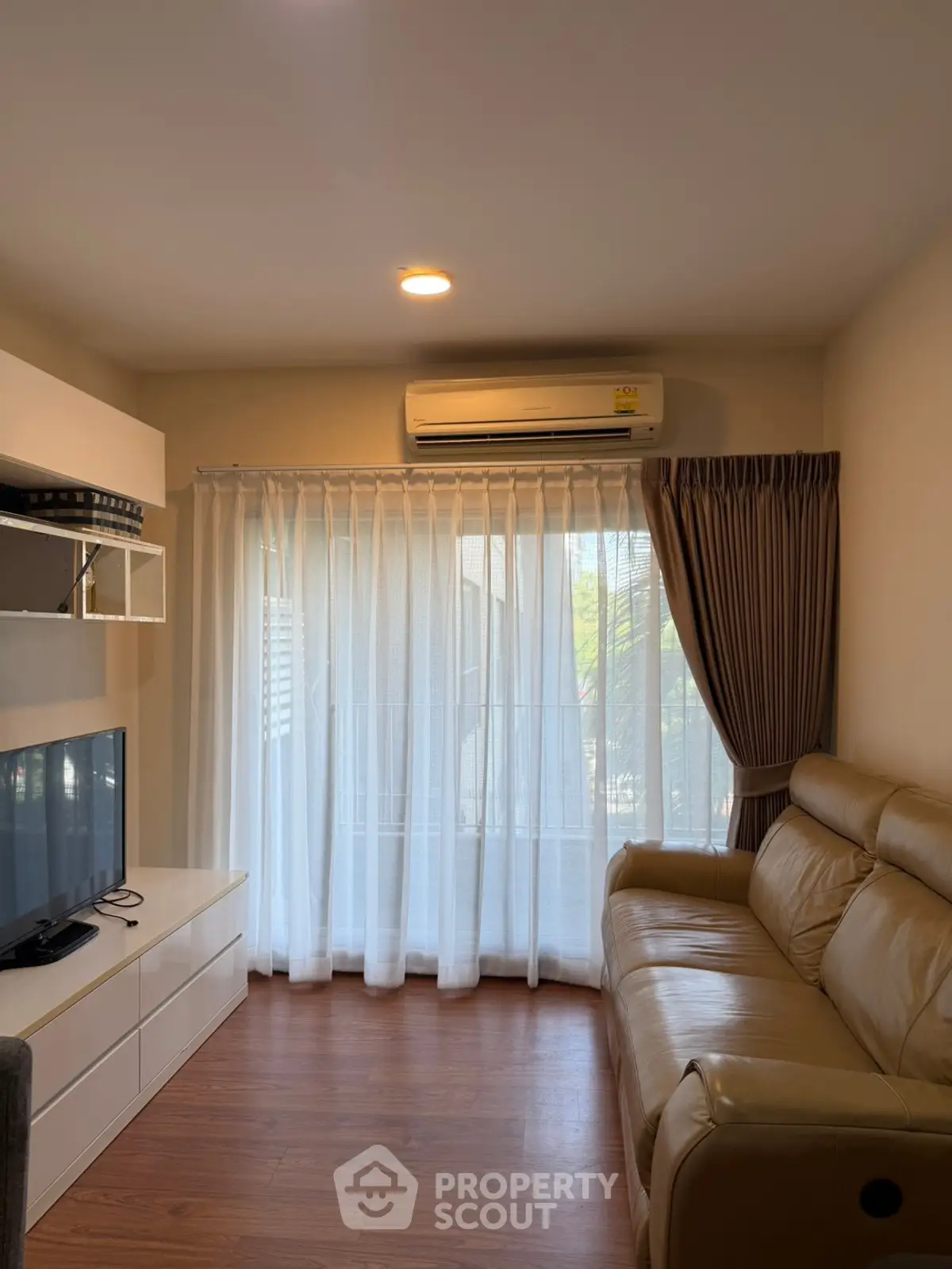 Cozy living room with leather sofa and natural light