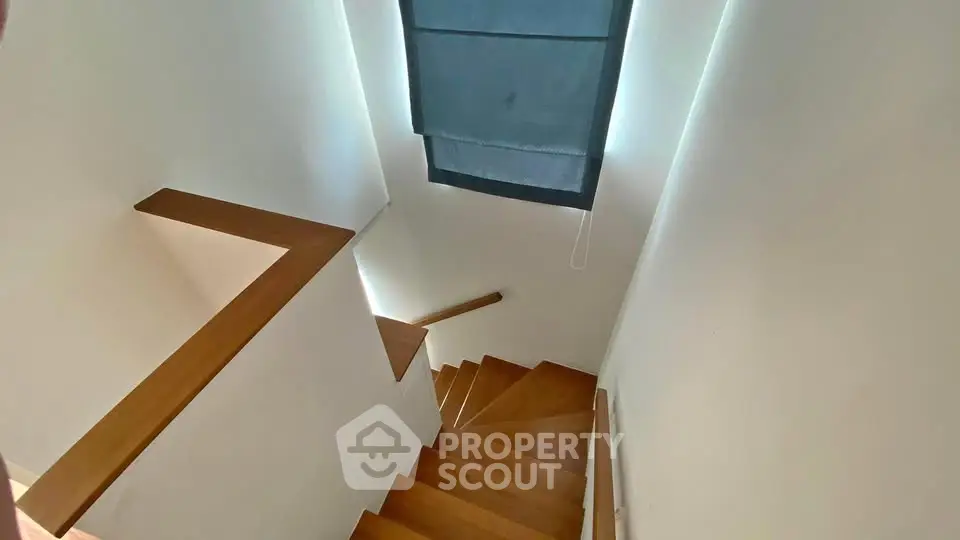 Elegant wooden staircase with natural light and modern design