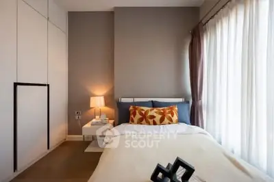 Cozy modern bedroom with stylish decor and ample natural light