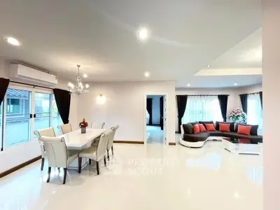 Spacious modern living room with elegant dining area and stylish corner sofa, perfect for family gatherings.