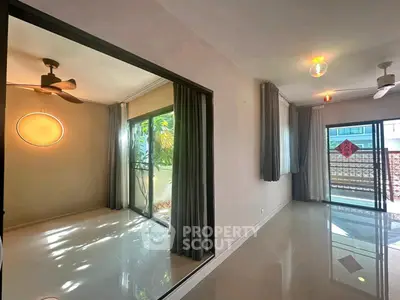 Spacious modern apartment with large windows and sleek flooring, offering abundant natural light and a serene ambiance.