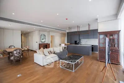 Spacious modern living room with open kitchen and elegant furnishings