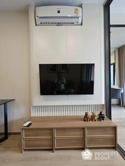 Modern living room with wall-mounted TV and air conditioning unit