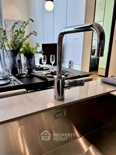Modern kitchen with sleek faucet and elegant dining setup