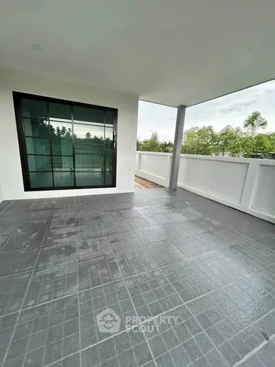 Spacious balcony with modern tiles and scenic view, perfect for relaxation and outdoor gatherings.