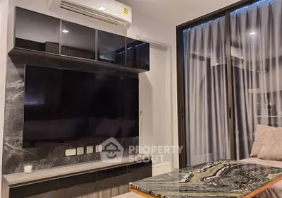 Modern living room with sleek TV unit and elegant marble table.