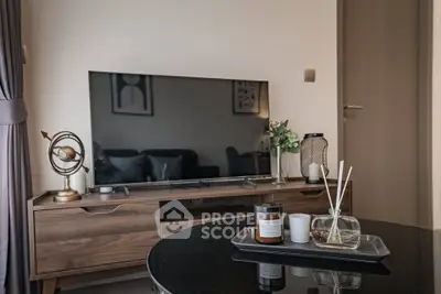 Stylish living room with modern decor and flat-screen TV, perfect for relaxation and entertainment.