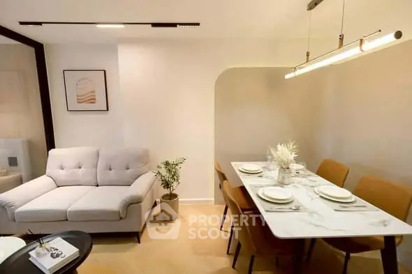 Modern living room with stylish dining area and elegant lighting