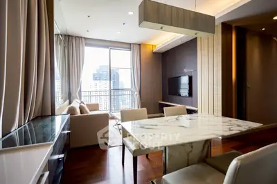 Luxurious modern living room with marble dining table and city view balcony.