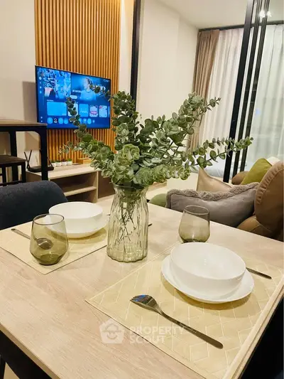 Modern living room with stylish decor and dining setup, featuring a cozy ambiance and elegant furnishings.
