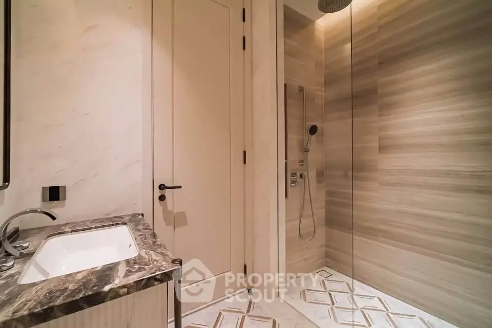 Luxurious modern bathroom with marble sink and spacious walk-in shower