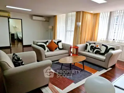 Spacious living room with modern decor and ample natural light