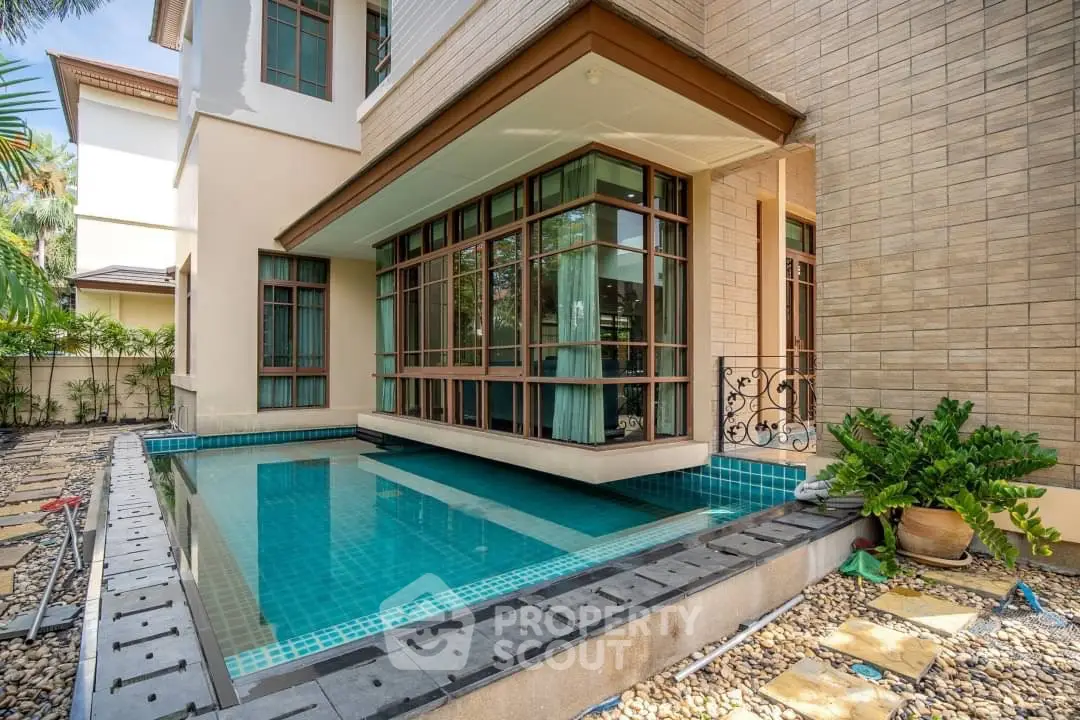 Luxurious modern home exterior with private pool and elegant architectural design.