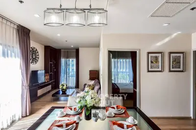 Elegant open-plan living and dining area with modern decor and natural light