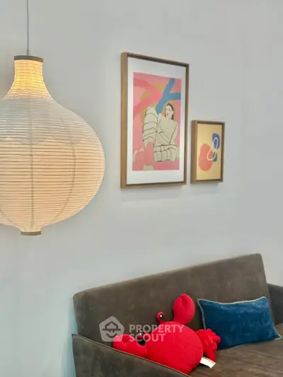 Stylish living room with modern art and cozy sofa, perfect for relaxation.