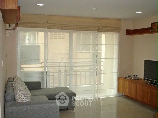Spacious living room with modern sofa and large window for natural light.