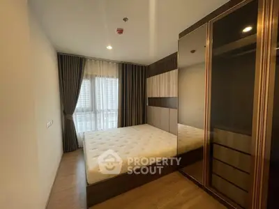 Modern bedroom with stylish wardrobe and large window in a contemporary apartment.