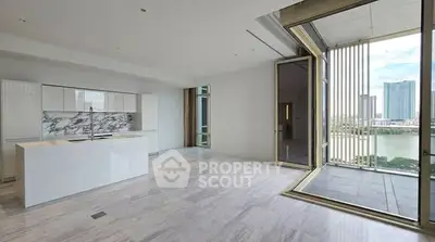 Luxurious open-plan living room with modern kitchen and stunning city view from large balcony.