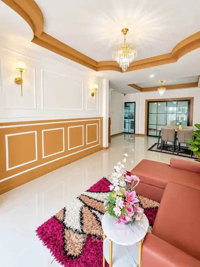 Elegant living room with modern decor, stylish lighting, and vibrant rug enhancing the luxurious ambiance.