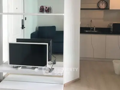 Modern open-layout living room with sleek kitchen and stylish decor