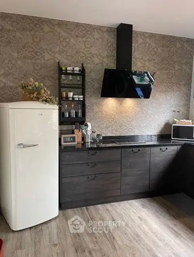 Stylish modern kitchen with dark cabinets and vintage fridge