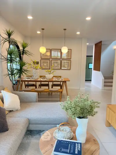 Stylish open-plan living and dining area with modern decor and cozy ambiance.