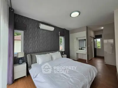 Spacious modern bedroom with stylish decor and natural light