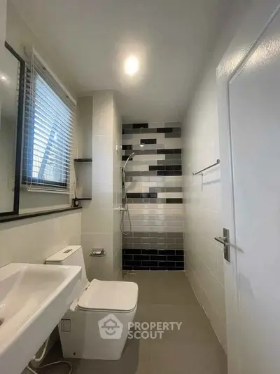 Modern bathroom with sleek design and stylish black and white tiles