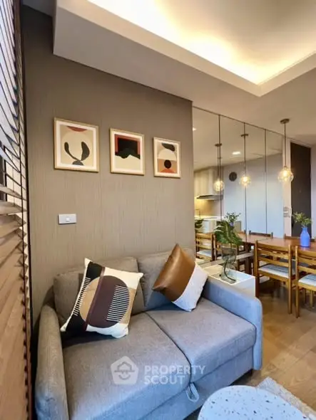 Stylish modern living room with cozy sofa and elegant dining area
