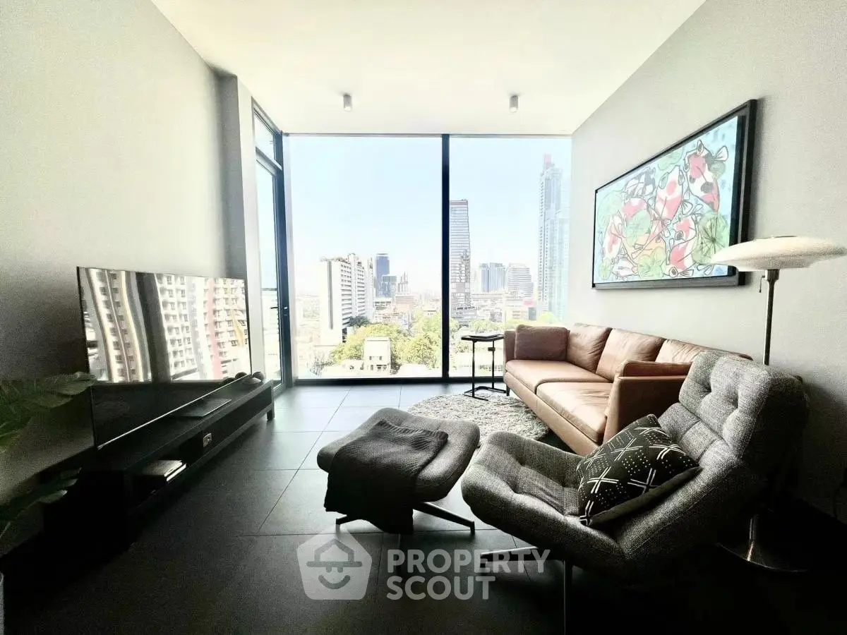 Modern living room with stunning city view, stylish furniture, and large windows in a high-rise apartment.