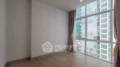 Spacious empty room with large windows and city view in modern apartment