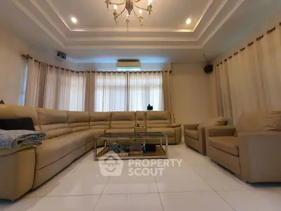 Spacious living room with elegant chandelier and cozy seating area