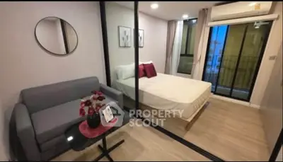 Modern compact bedroom with glass partition and cozy decor