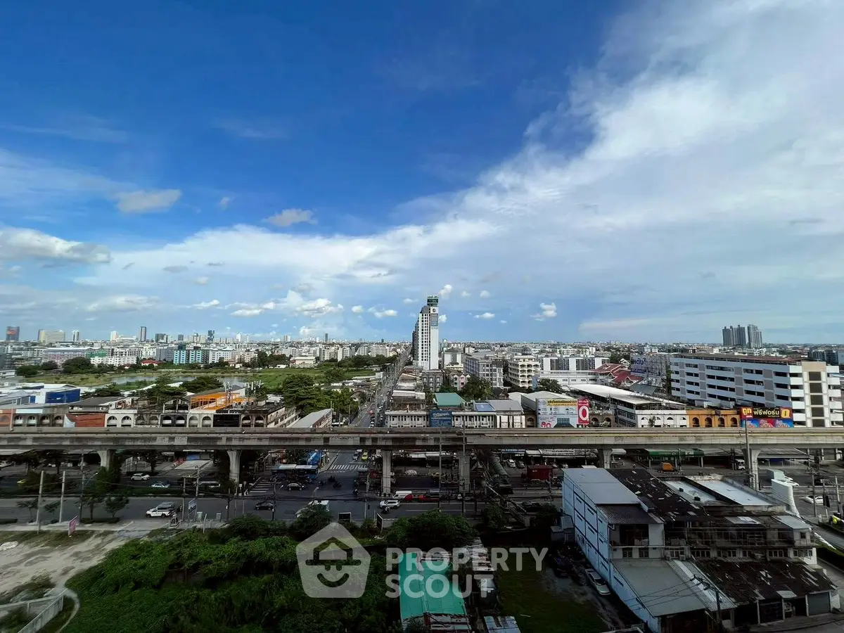 Stunning cityscape view with clear blue skies and urban skyline, perfect for real estate investment.
