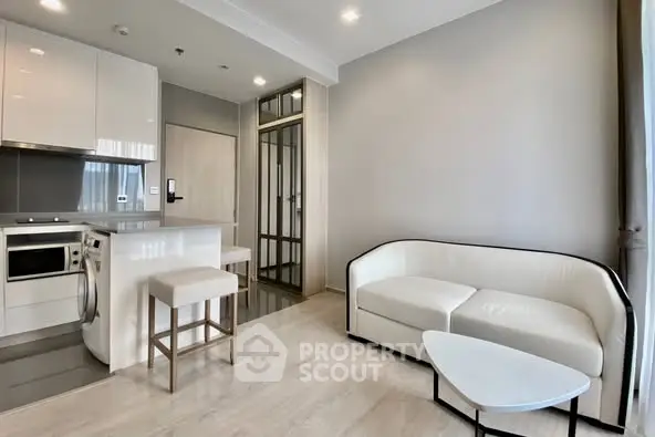 Modern open-plan living room with sleek kitchen and stylish furniture